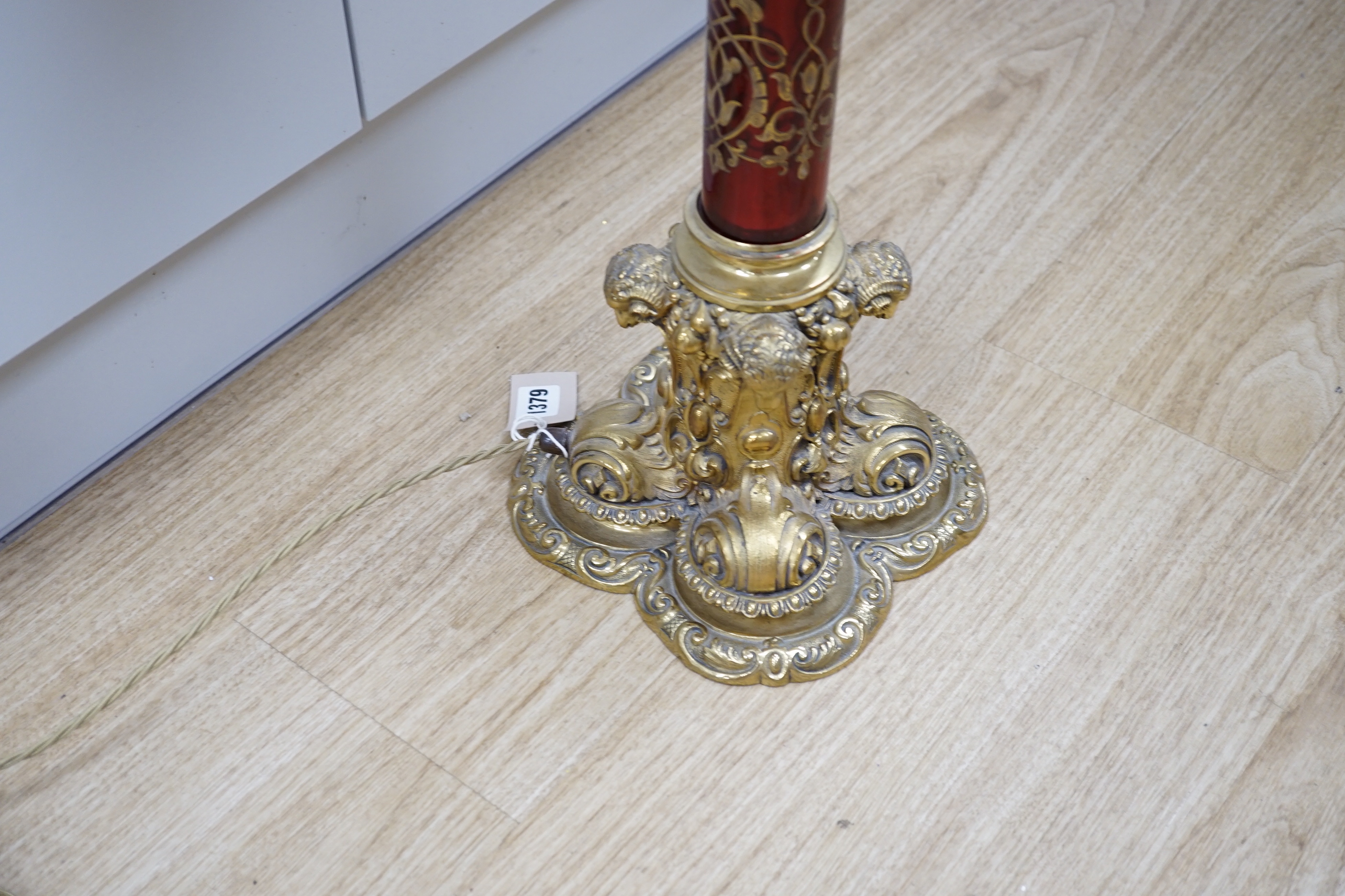 A Victorian style brass and ruby glass table lamp with shade, 81cm